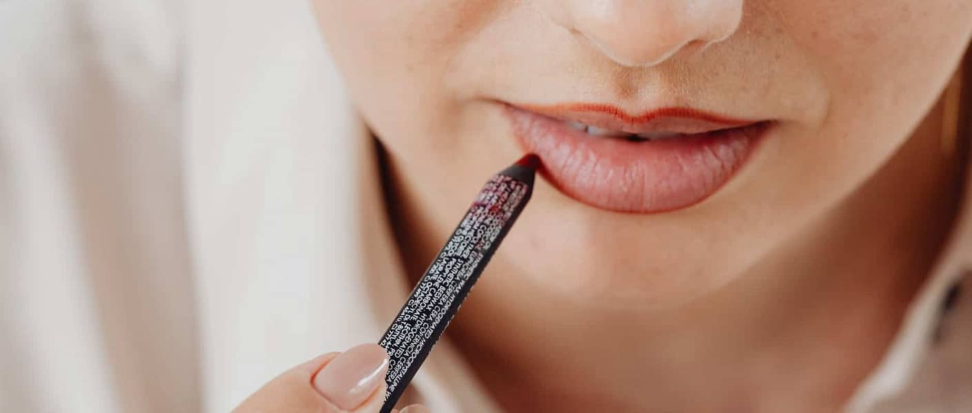 a person applying lip liner