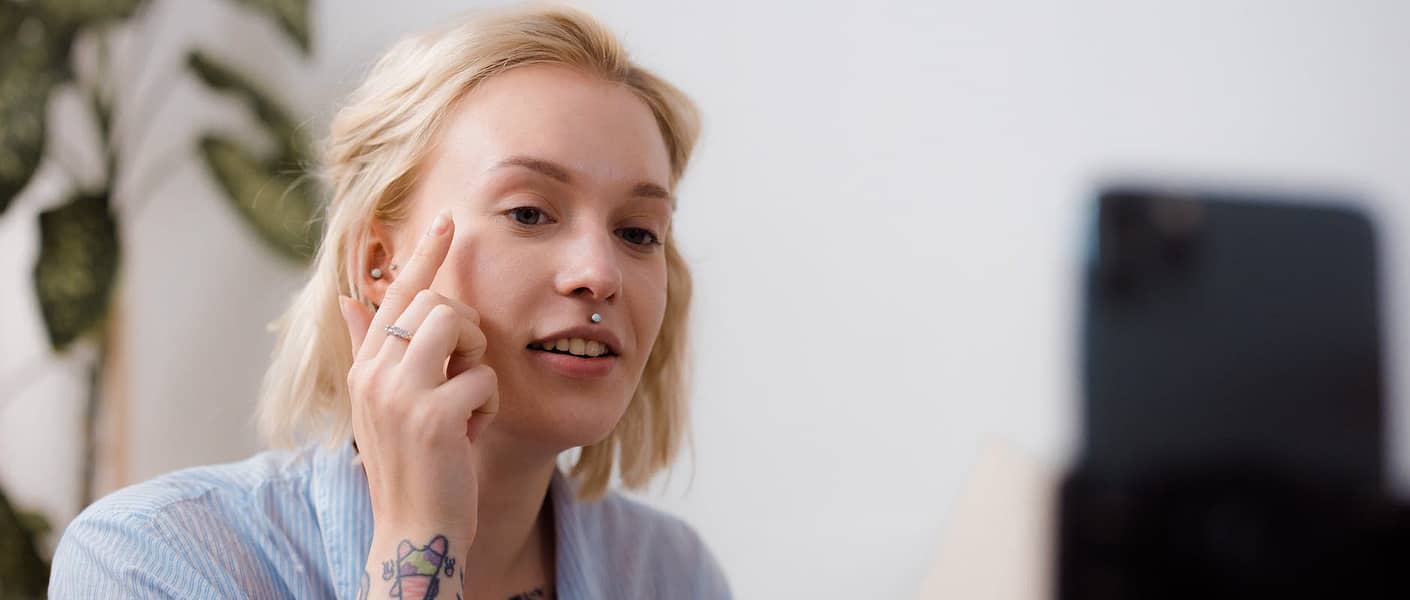 a woman vlogging while applying makeup