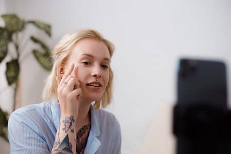 a woman vlogging while applying makeup