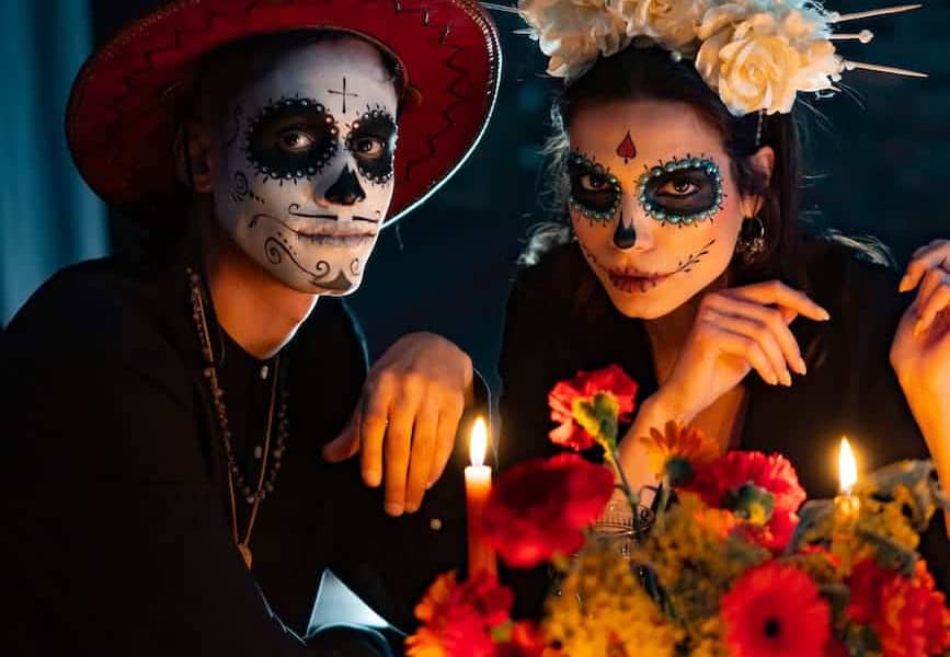 man and woman with scary makeup looking at camera